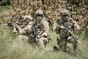 United States Army ranger during the military operation. Professional marine soldiers training with weapon on a military range.