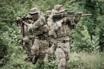 United States Army ranger during the military operation. Professional marine soldiers training with weapon on a military range.