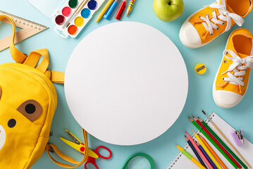 Catch eye of parents and educators with a top-down image of yellow child backpack filled with colorful school supplies and sneakers on pastel blue isolated backdrop, perfect for educational campaigns