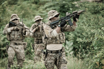 Fototapeta premium United States Army ranger during the military operation. Professional marine soldiers training with weapon on a military range.