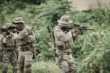 Fototapeta premium United States Army ranger during the military operation. Professional marine soldiers training with weapon on a military range.