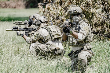 United States Army ranger during the military operation. Professional marine soldiers training with weapon on a military range.