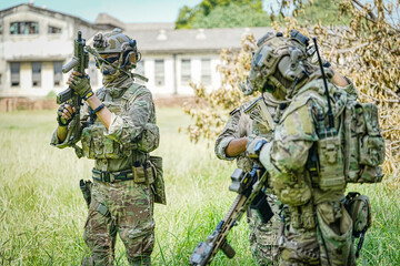 Fototapeta premium United States Army ranger during the military operation. Professional marine soldiers training with weapon on a military range.