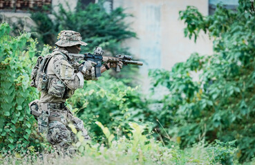 United States Army ranger during the military operation. Professional marine soldiers training with...