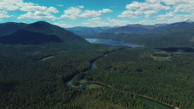 Serene Priest Lake Surrounded By Lush Pine Forest In Idaho, USA. wide aerial