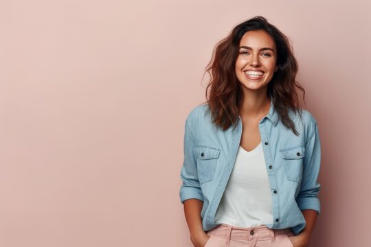 Portrait Of A Happy Young Woman Smiling And Looking At Camera Isolated Over Pink Background