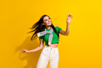 Photo of carefree stunning cheerful person chilling dancing empty space new clothes collection ad isolated on yellow color background