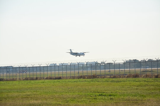 the air plane is landing on the  ranway