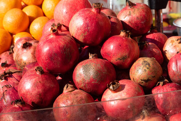Brightly colored Pomegranates juicy, sweet fruits with edible seeds seasonal fruit they're rich in fiber, vitamins, and minerals, full of antioxidants and anti-inflammatory compounds