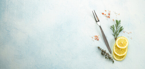 kitchen cooking background with lemon, herbs and fork, Long banner format. top view