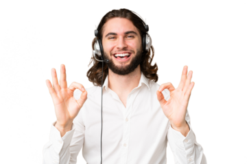 Telemarketer man working with a headset over isolated chroma key background showing an ok sign with fingers