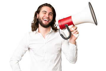 Young handsome man over isolated chroma key background holding a megaphone and smiling