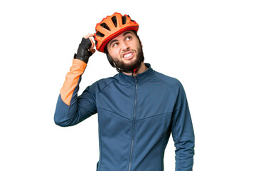 Young cyclist man over isolated chroma key background having doubts and with confuse face expression