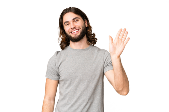 Young handsome man over isolated chroma key background saluting with hand with happy expression