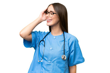 Young nurse caucasian woman over isolated background has realized something and intending the solution