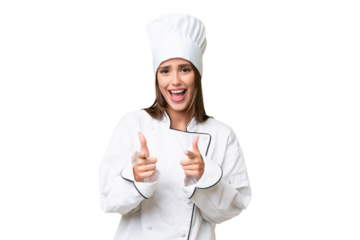 Young chef caucasian woman over isolated background pointing to the front and smiling