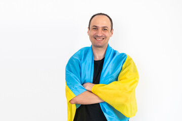 Handsome man with flag of Ukraine at home.