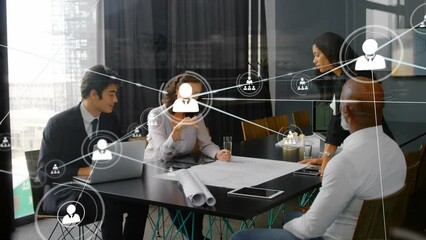 Animation of connected icons over diverse coworkers discussing reports in meeting at office - Powered by Adobe