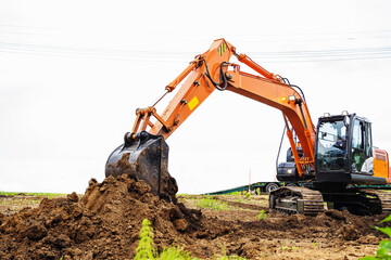 The excavator digs the ground. The work of heavy equipment on the laying of a pipeline or other...