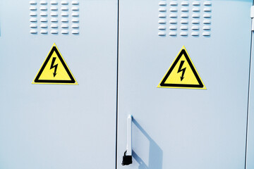 Metal door of the transformer box with symbols and signs for the precaution of electric shock....