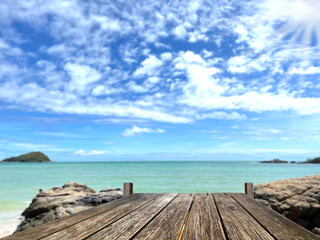 Wooden table, wooden bridge in blurred sea background