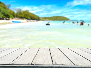 Fototapeta premium Wooden table, in blurred sea background