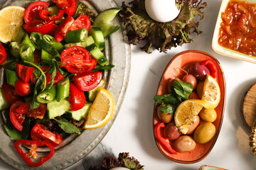 Traditional Turkish Breakfast served with traditional turkish tea on marble table, traditional Turkish breakfast of sliced tomatoes, peppers and cucumbers
