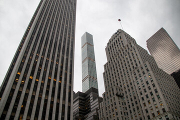 Fototapeta premium 432 Park Avenue visible between older New York skyscrapers, view from Central Park on a cloudy day.
