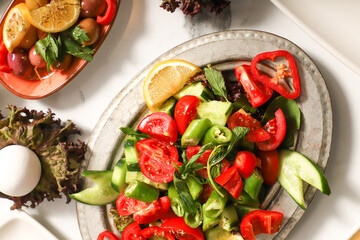 Traditional Turkish Breakfast served with traditional turkish tea on marble table, traditional Turkish breakfast of sliced tomatoes, peppers and cucumbers