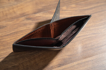 Empty wallet on the wooden table.