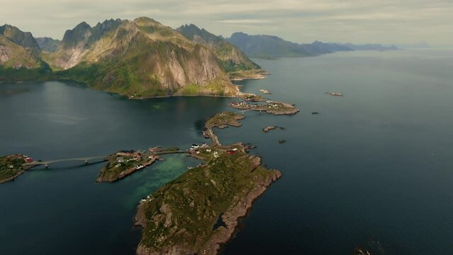 Drone flies over over the small inhabited islands and the highway connecting them in stunning nordic scenery