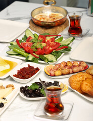 Traditional Turkish Breakfast served with traditional turkish tea on marble table