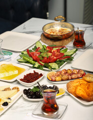 Traditional Turkish Breakfast served with traditional turkish tea on marble table