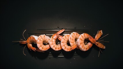 group of shrimp on a grill with toothpicks - obrazy, fototapety, plakaty