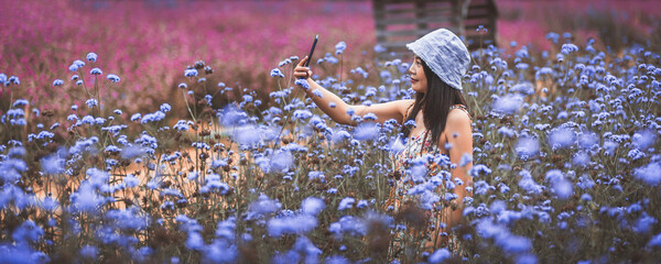Traveler asian woman with mobile phone selfie and travel in flower garden at Khao Yai Thailand - 625885004