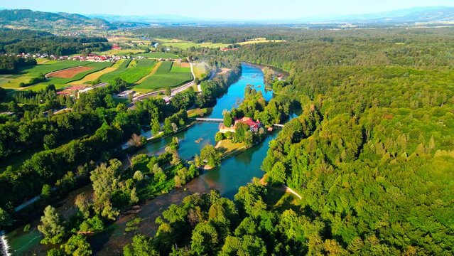 Picturesque 4K drone footage of Castle Otočec in beautiful sunny light. Video shows this historic gem embraced by the Krka River. Captivating Slovenia's beauty from aerial perspective.