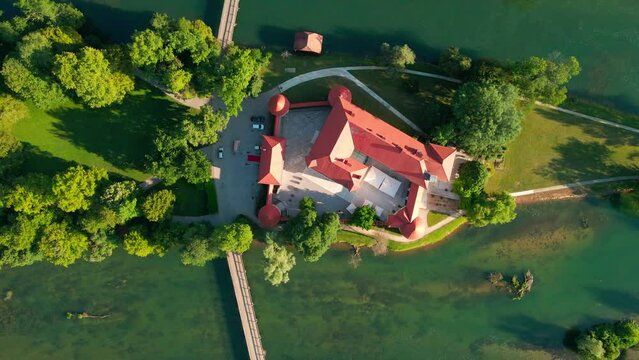 Picturesque 4K drone footage of Castle Otočec in beautiful sunny light. Video shows this historic gem embraced by the Krka River. Captivating Slovenia's beauty from aerial perspective.