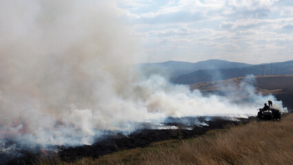 Fototapeta na wymiar Fire Management - Burning firebreaks in the KwaZulu-Natal Midlands, South Africa