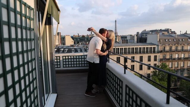 Romantic Couple Kissing on Paris Balcony with view of Eiffel Tower, Cinematic