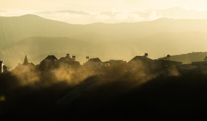 sunrise over the mountains with cloud in the town