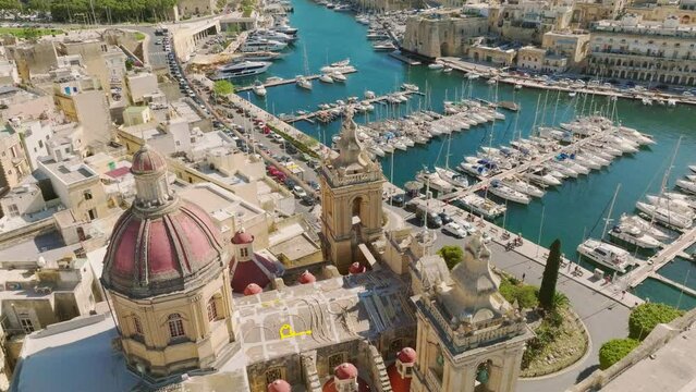 Aerial drone view of the church of famous maltese old city Birgu, marina, yachts, boats. Malta island