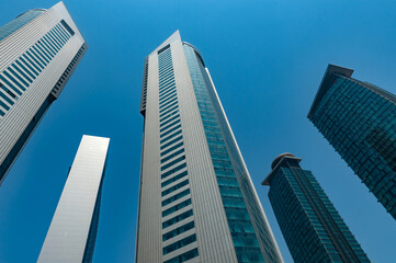 Fototapeta na wymiar Modern glass fronted skyscrapers and office towers line the Doha skyline, Qatar. Middle East business property