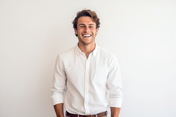 Portrait of handsome young man smiling and looking at camera on white background - obrazy, fototapety, plakaty