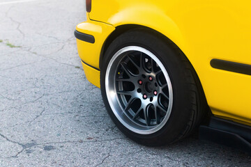 Lowrider custom stance stylish sports car closeup. Yellow car