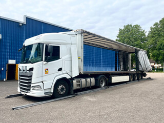 Fototapeta na wymiar An open semi-trailer curtain on both sides for loading the goods