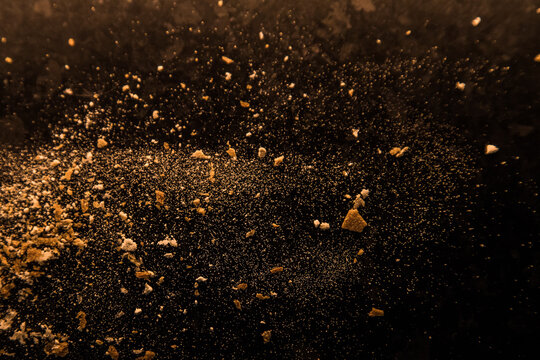 Abstract image made with flour and breadcrumbs on dark background. Conceptual image, alluding to space and cosmos, the unknown, light and darkness.
