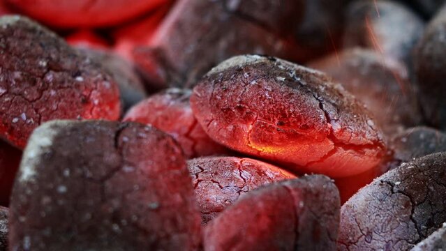 Glowing Charcoal Briquettes, BBQ oder close up of coals burning
