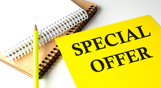 SPECIAL OFFER text written on a yellow paper with notebook
