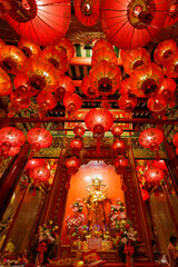 Guan Yin shrine and red Chinese lanterns - 625913669