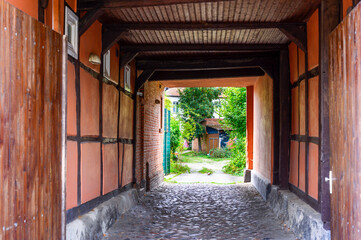 View of a gateway to a backyard in a historic building in Salzwedel, Germany.